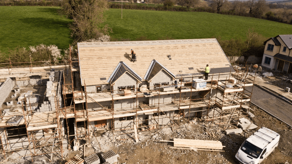 A long view of the house under construction
