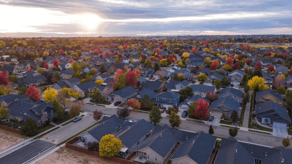 An aerial view of the neighborhood buildings in the autumn season