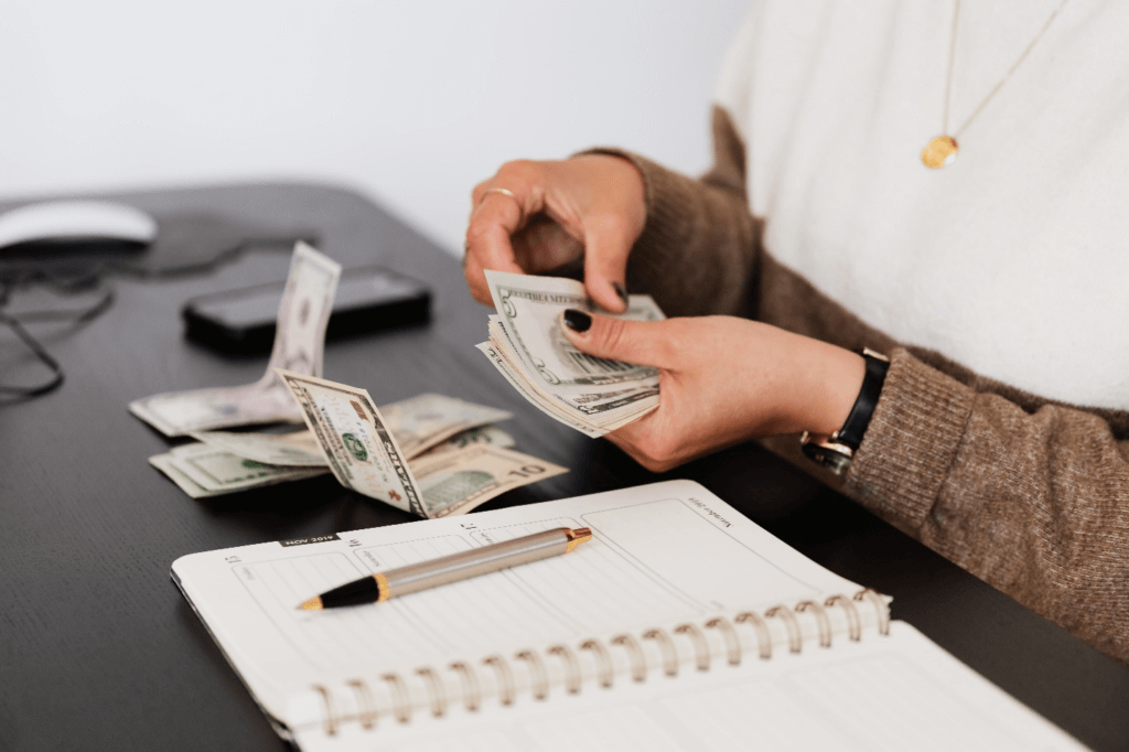 A clerk counting the money and noting down