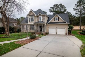 A brown and white house that has been constructed and ready for purchase by a client