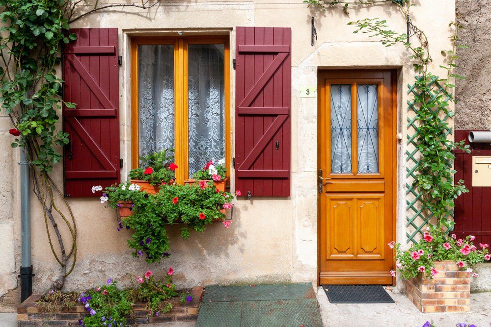 A wooden entrance door and the colorful windows