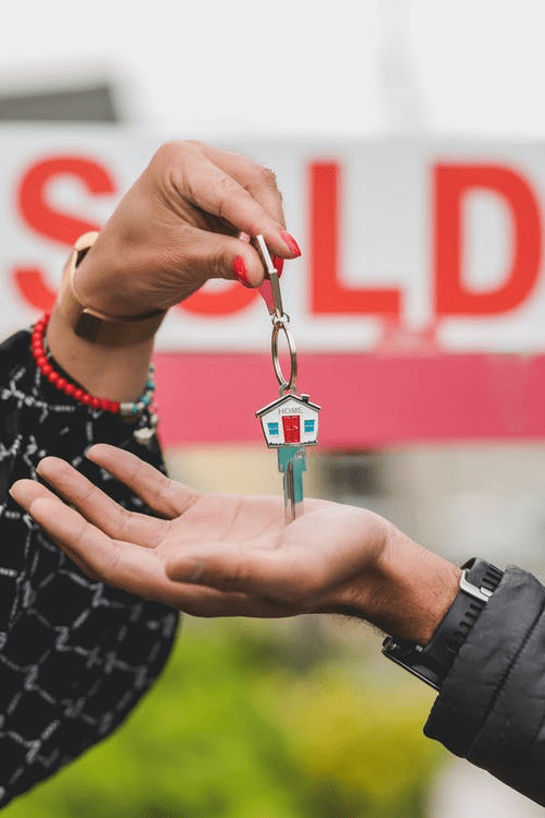 Woman Handling House Keys To A Man