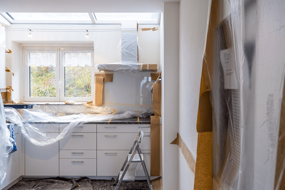  A Kitchen with Marble Countertops and White Furniture Undergoing Renovation