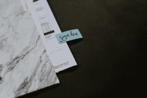 Property paperwork with a signature post-it