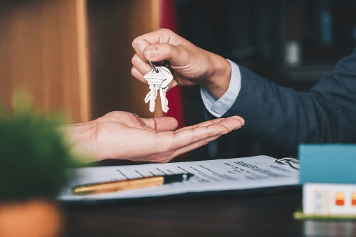 A person receiving their home keys