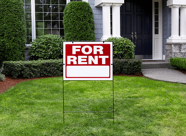  A “for rent” sign in front of a house 