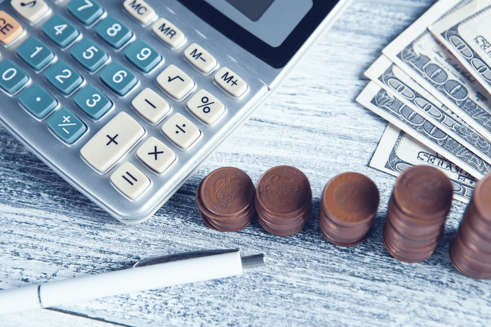 calculator and coin stacks