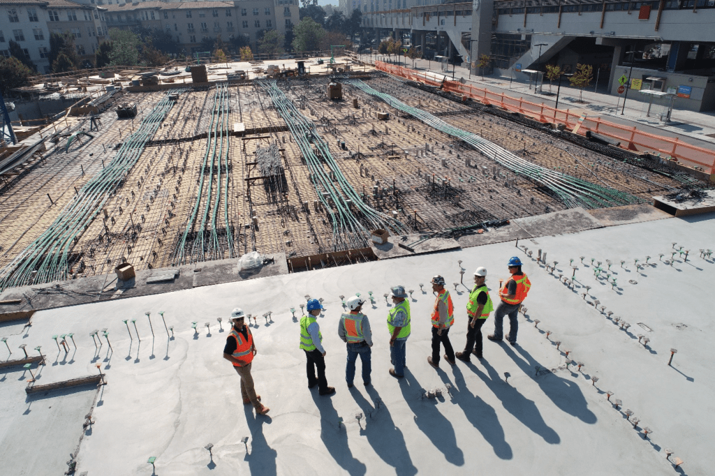 Construction workers standing at a construction site.