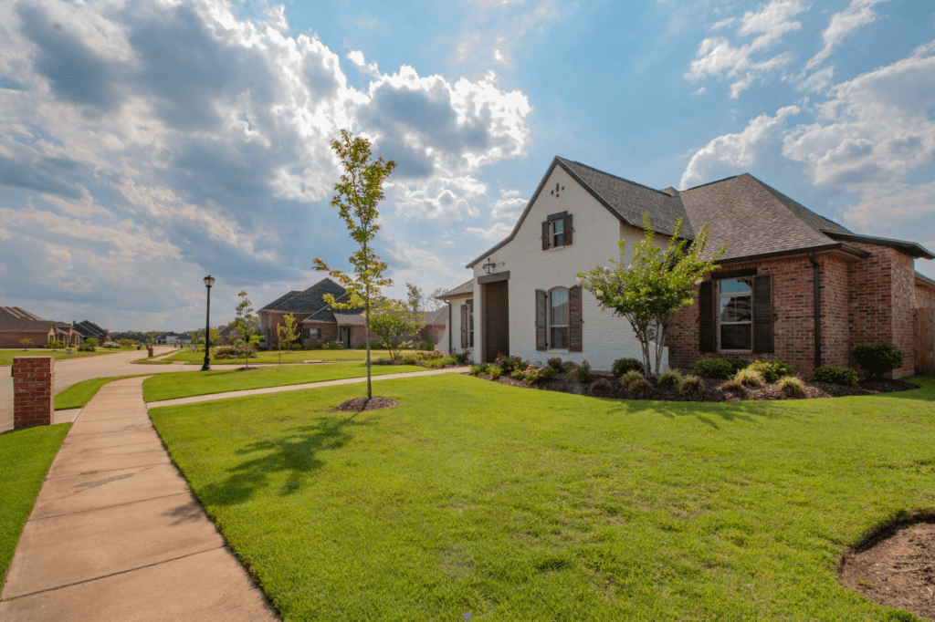 A home with a lawn and grass in front of it.