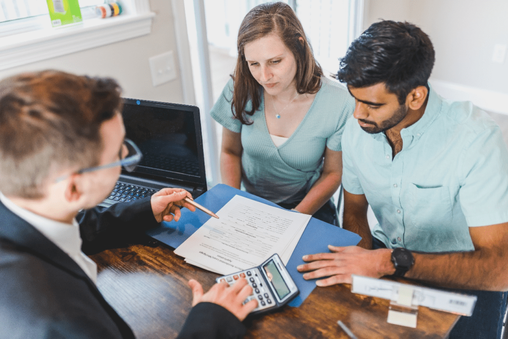 Couple discussing loan options with a financial expert.