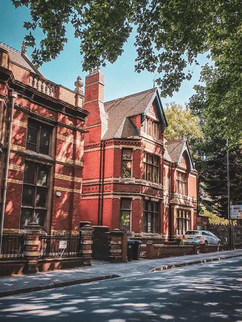 A photo showing brick houses along a street.