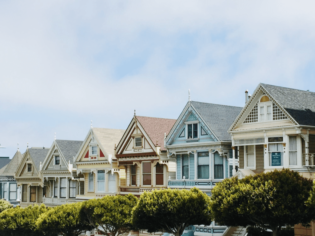 A photo showing a row of houses along a street.