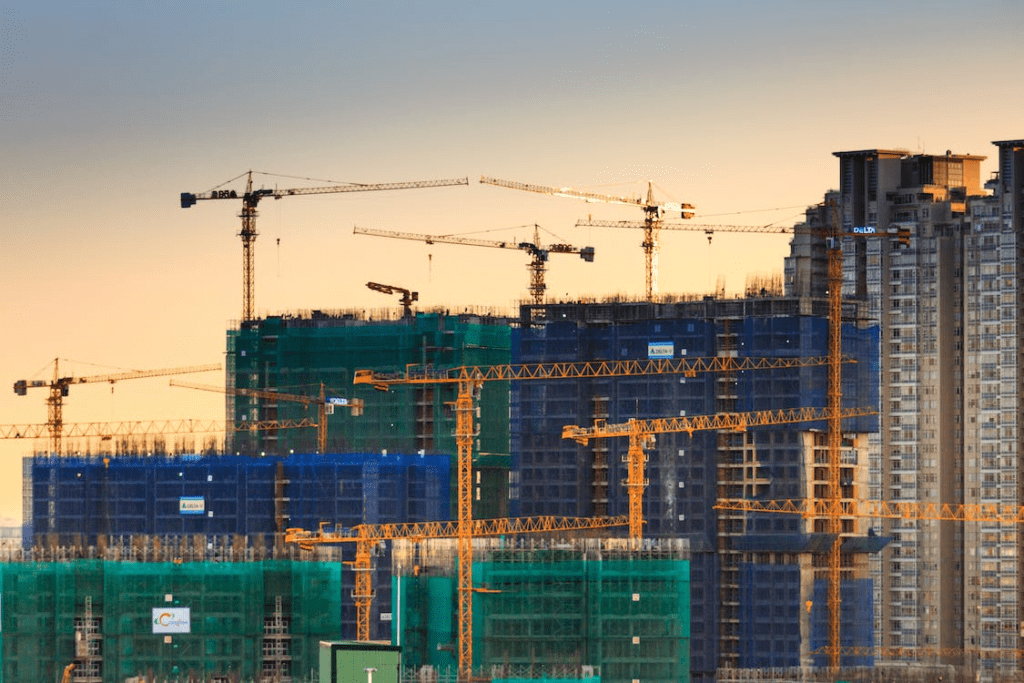 A photo showing building cranes at a construction site.