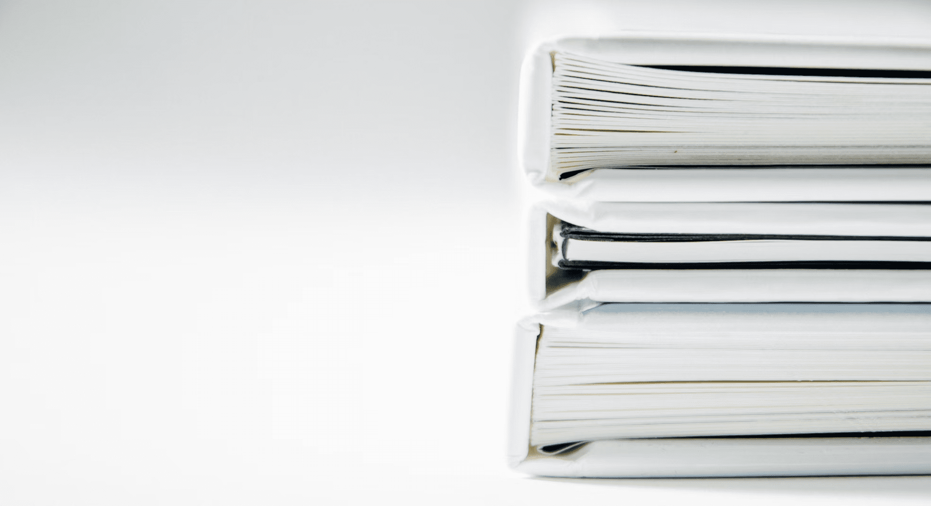  A photo showing a stack of white folders.