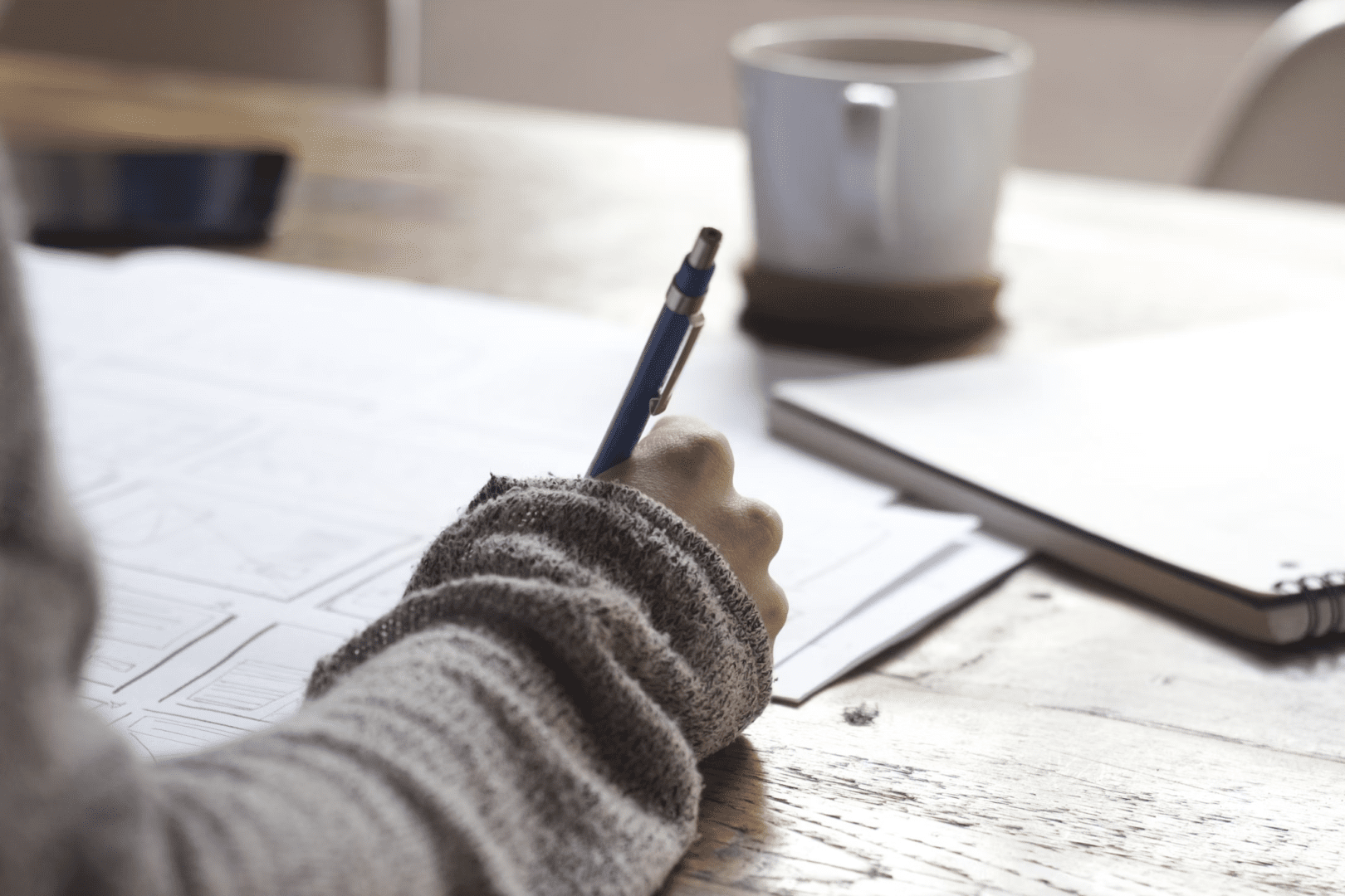  A photo showing a person writing on a document.