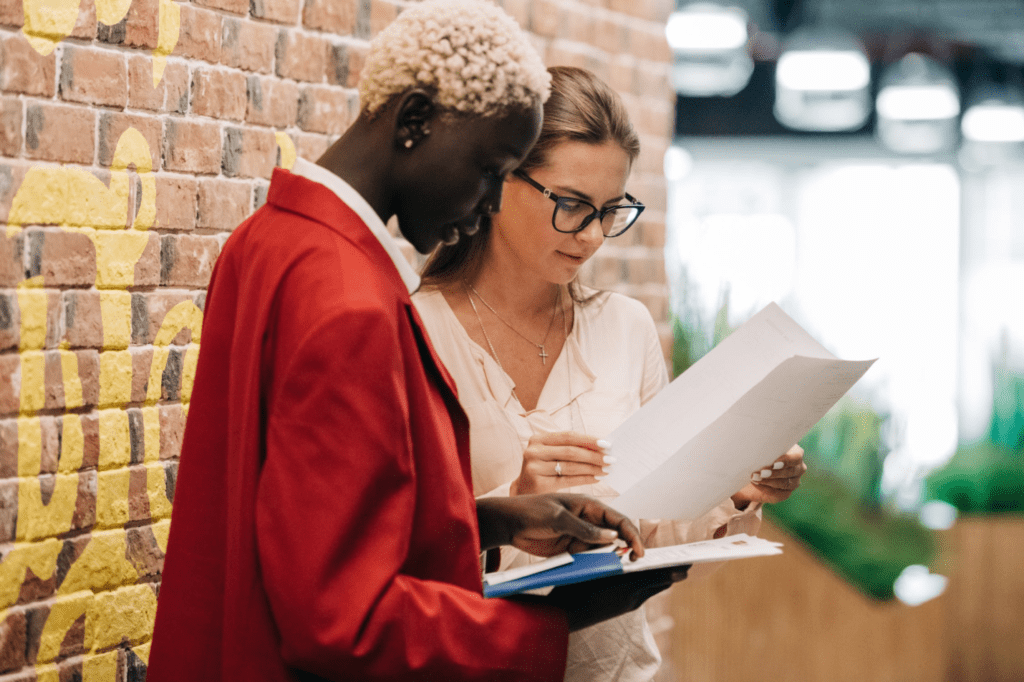  A photo showing two people examining a document.