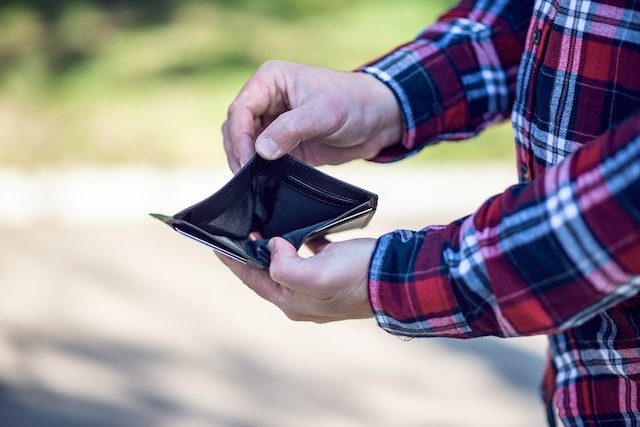 An individual showing an empty wallet