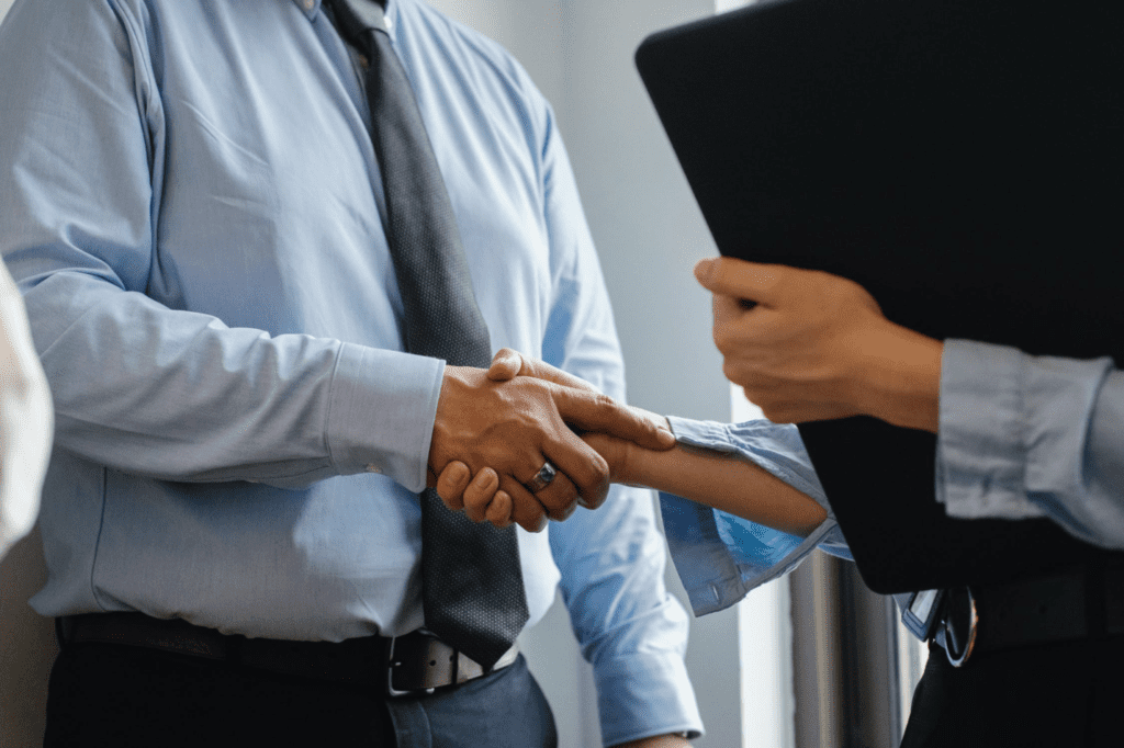 A photo showing two people shaking hands.