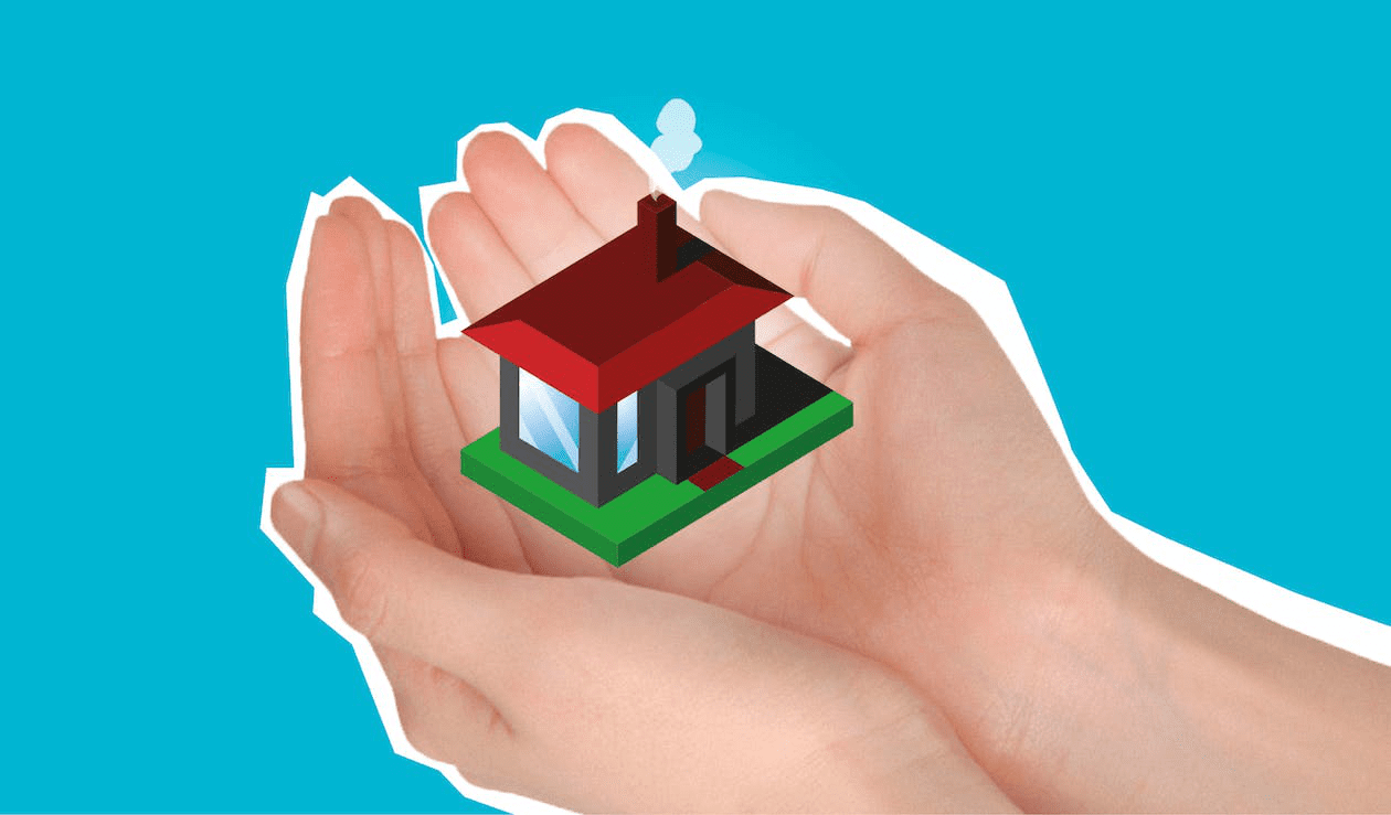 A person holding a model of a newly constructed house