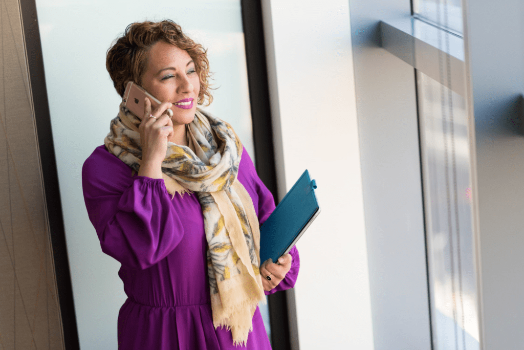 A photo showing a woman speaking on a smartphone.