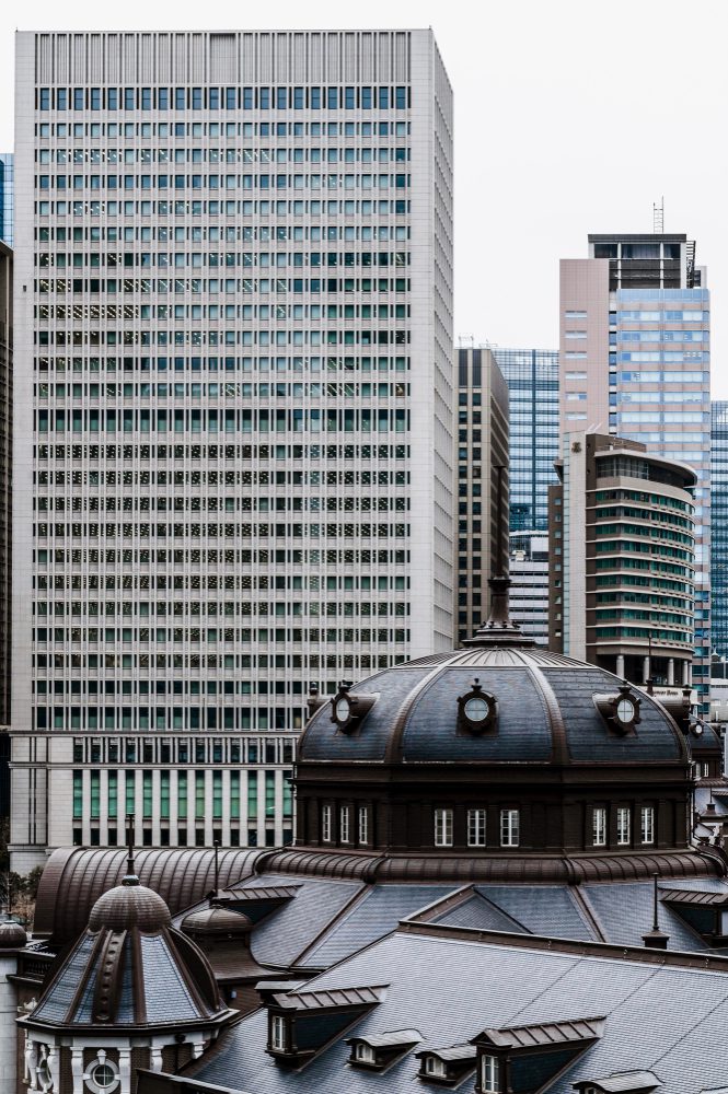 Urban contrast: historical dome architecture in foreground against modern skyscrapers.