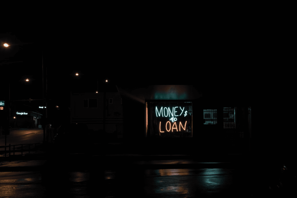 A photo showing a neon sign outside a business.