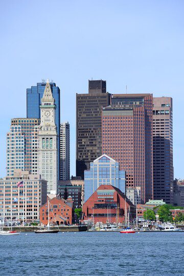 Boston skyline with a view of the waterfront and skyscrapers on a clear day.