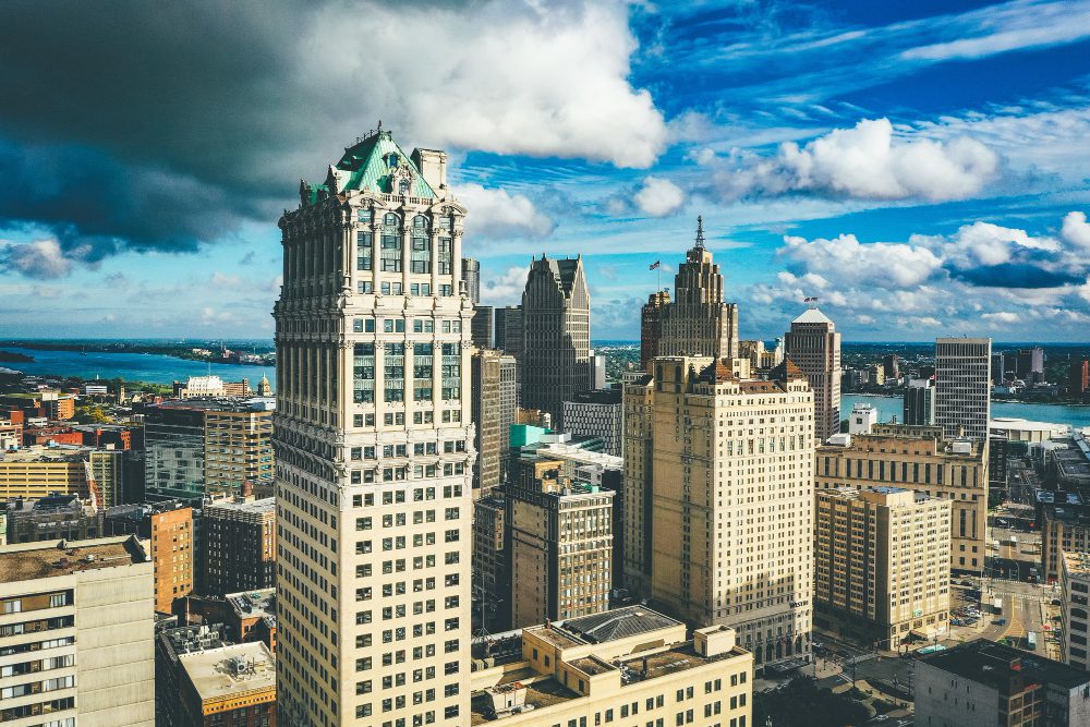 Aerial view of a historic urban skyline under partly cloudy skies.