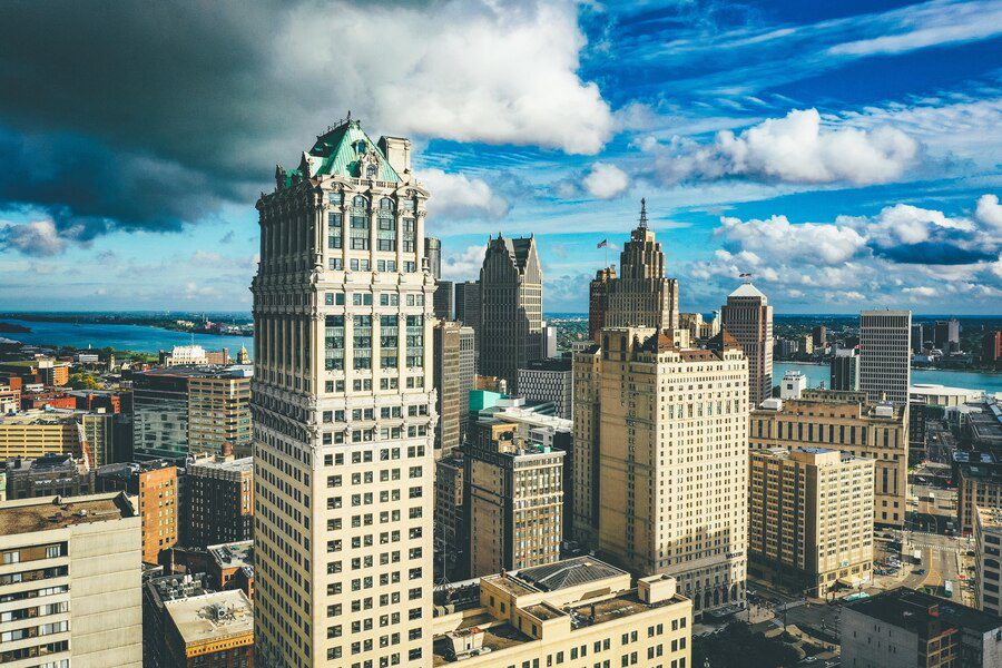 Aerial view of a cityscape with historic high-rise buildings under a cloudy sky.