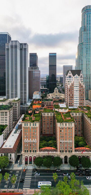 A vertical cityscape showing a mix of high-rise buildings and greenery in an urban environment.