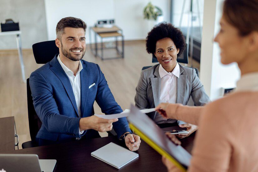 Business colleagues exchanging documents during a meeting.