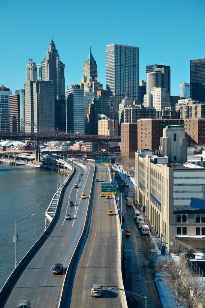 Elevated highway leading towards a city skyline on a clear day.