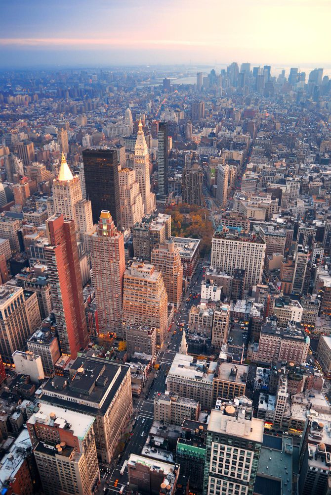 Aerial view of a densely packed urban cityscape during sunset.