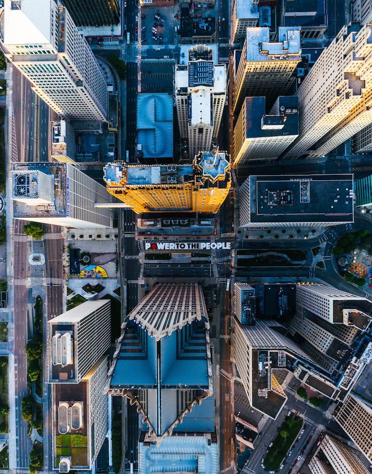 Aerial view of a dense urban street intersection with skyscrapers.