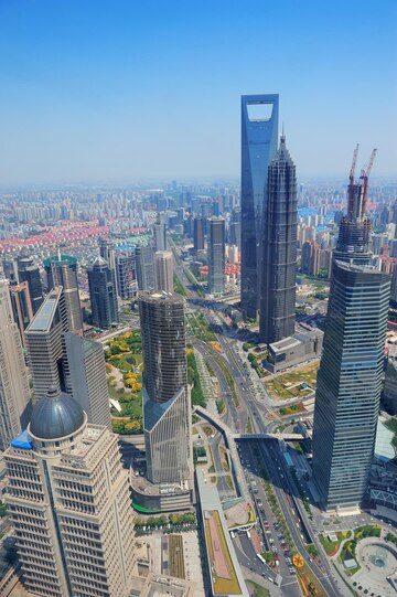 Aerial view of a modern city with skyscrapers and urban infrastructure.