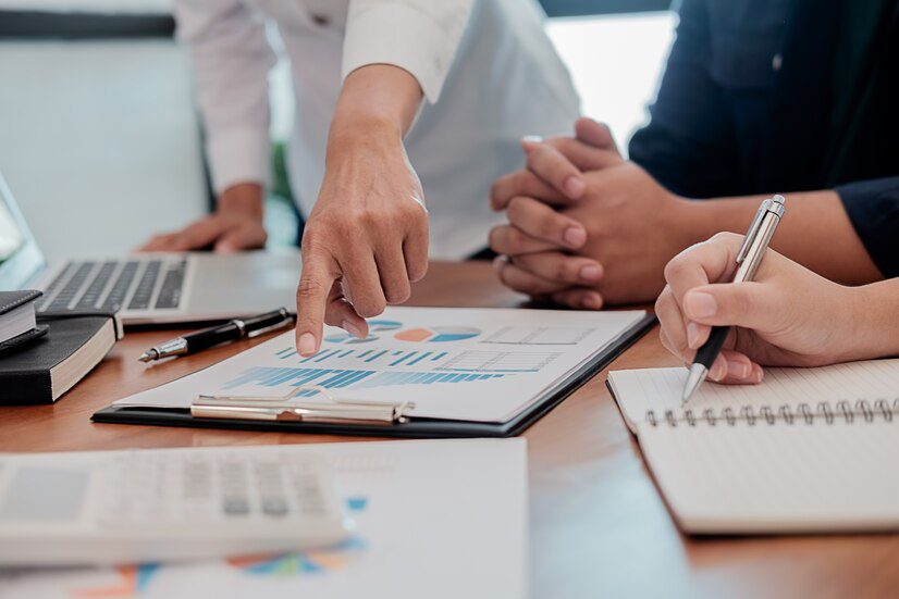 Professionals analyzing financial charts during a business meeting.