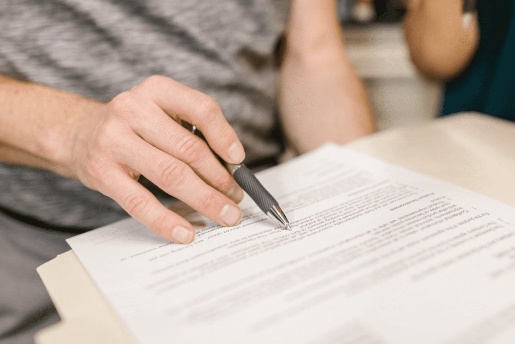 A person going through a lease agreement using a pen