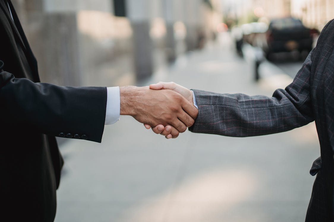 Two people shaking each other’s hands. 