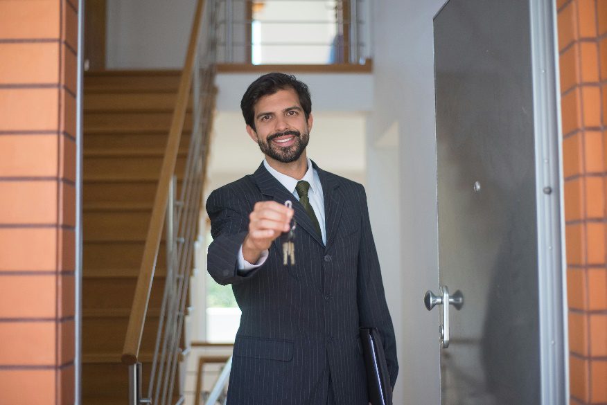 A person holding keys of a house