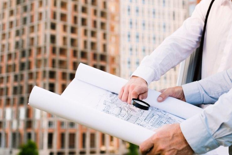 Close-up of people holding a building sketch