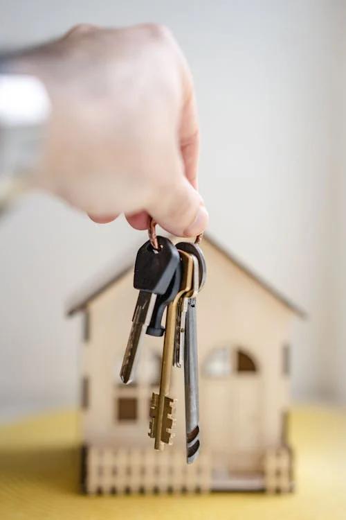 Person holding keys for a new real estate project,