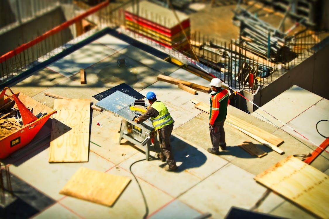 Two men on a construction site during daytime 