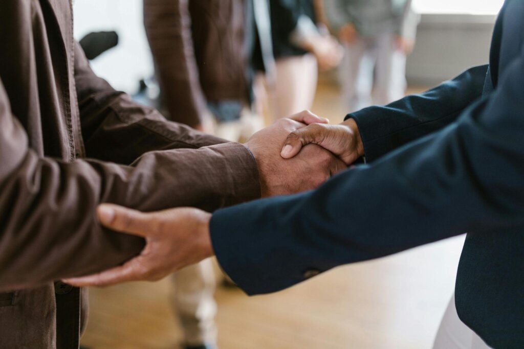 A close-up of two men shaking hands