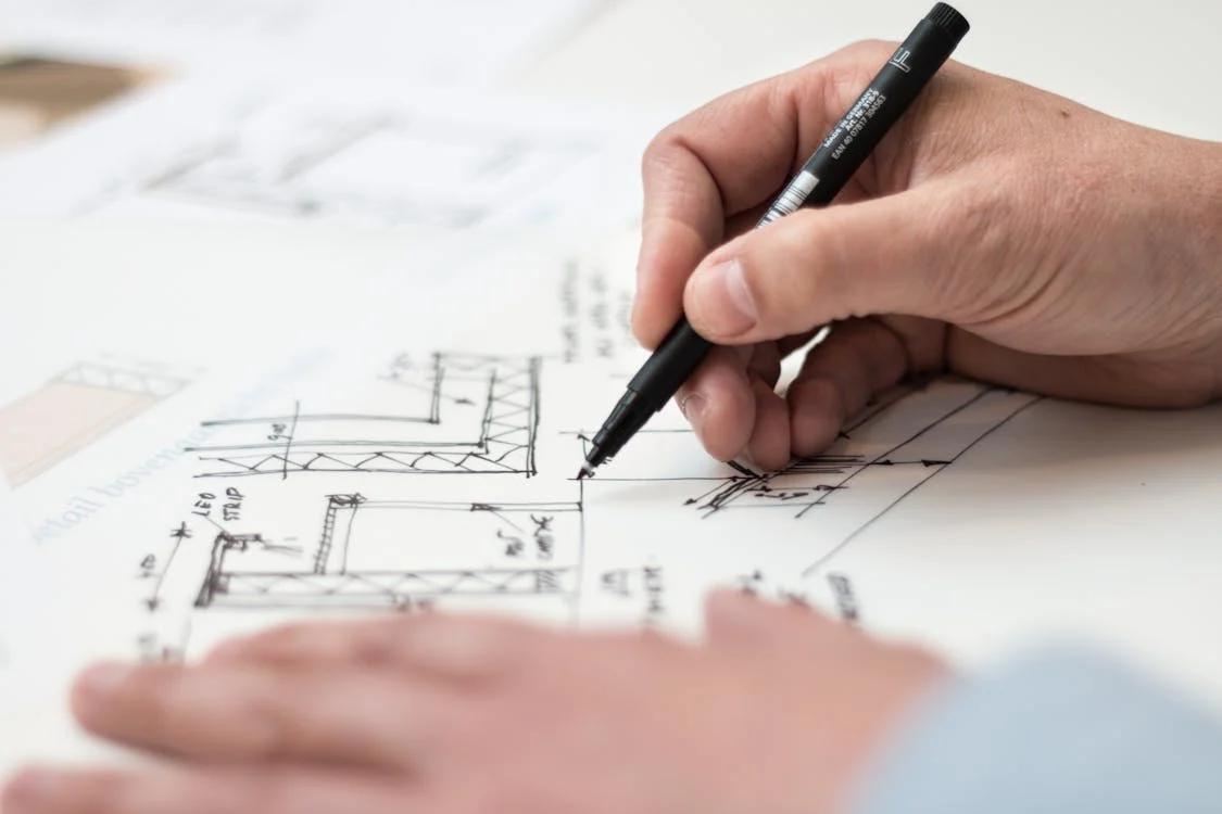 A person creating a floor plan for a new construction