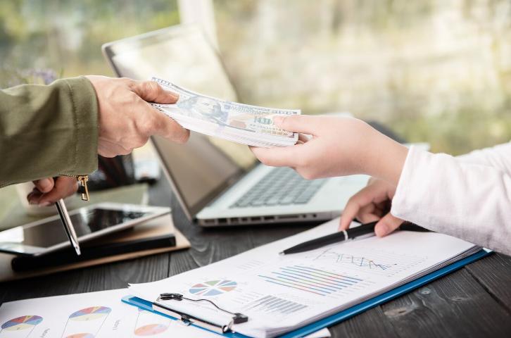 Money Lender Shaking Hands With a Client