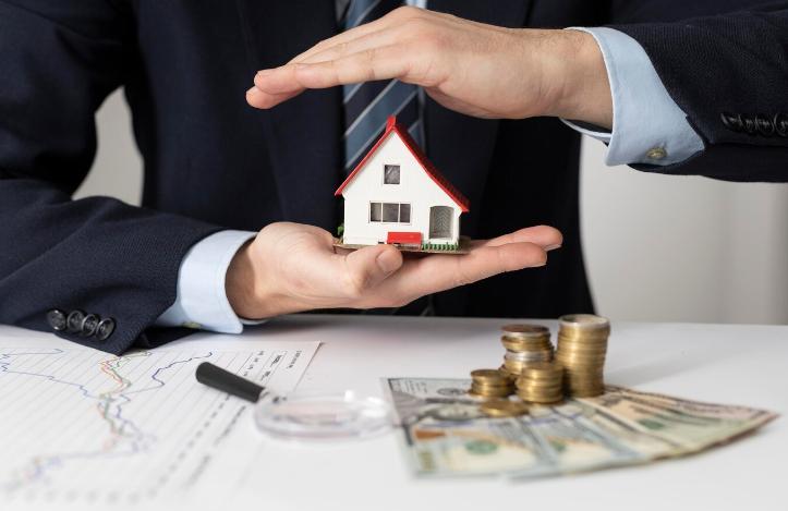 Money Lender Holding a Miniature House