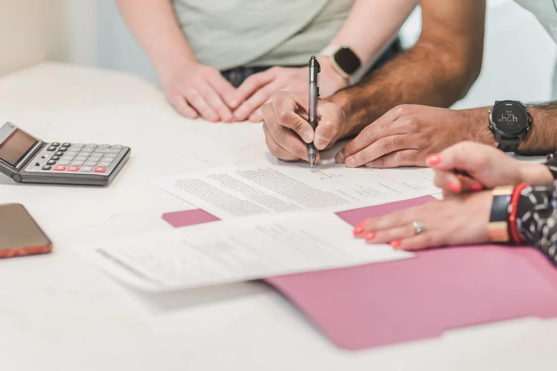 A person signing a loan agreement 