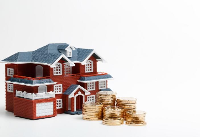 Money In Front of Miniature House