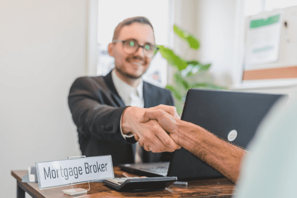 A mortgage broker shaking hands with a client