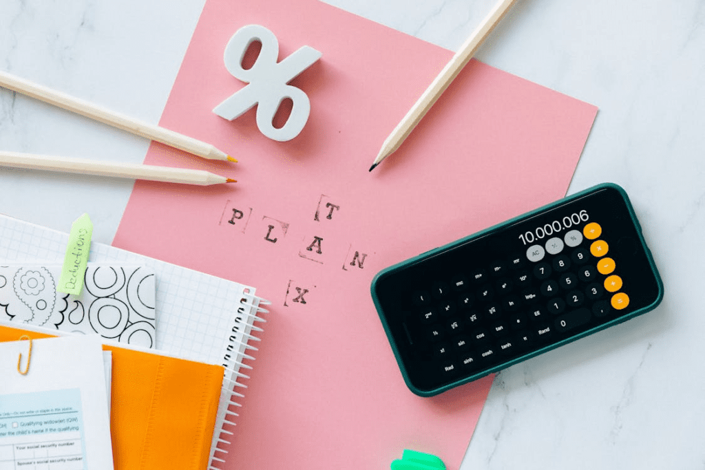 Calculator, pen, and papers for tax calculation